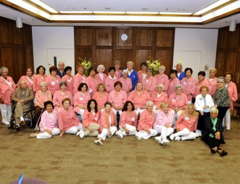 Long shot group photo of smiling Beverly Guild volunteer members