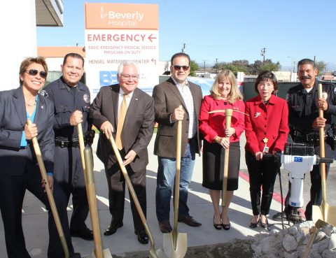 Community stakeholders smile while holding shovels at the Emergency Care Center groundbreaking ceremony