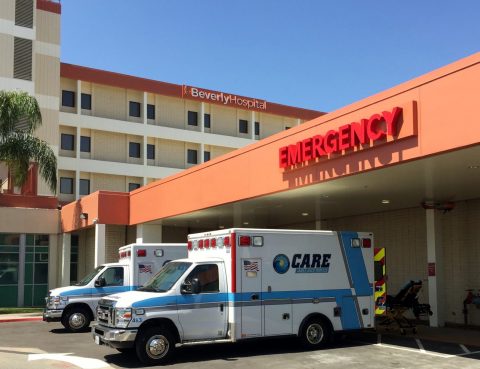 Day photo with 2 ambulances outside of the Emergency Care Center
