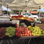 A variety of fruits(grapes, pomegranate, and lemons in the foreground) at the Beverly Hospital farmers market