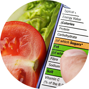 Close up of nutrition label next to a tomato and lettuce head