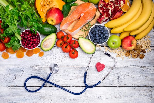 Overview display with a stethoscope and healthy foods such as fruits, vegetables, meats and nuts.